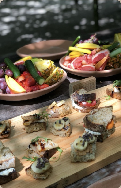 Local fruit and canapé spread laid out for guests on a wooden table