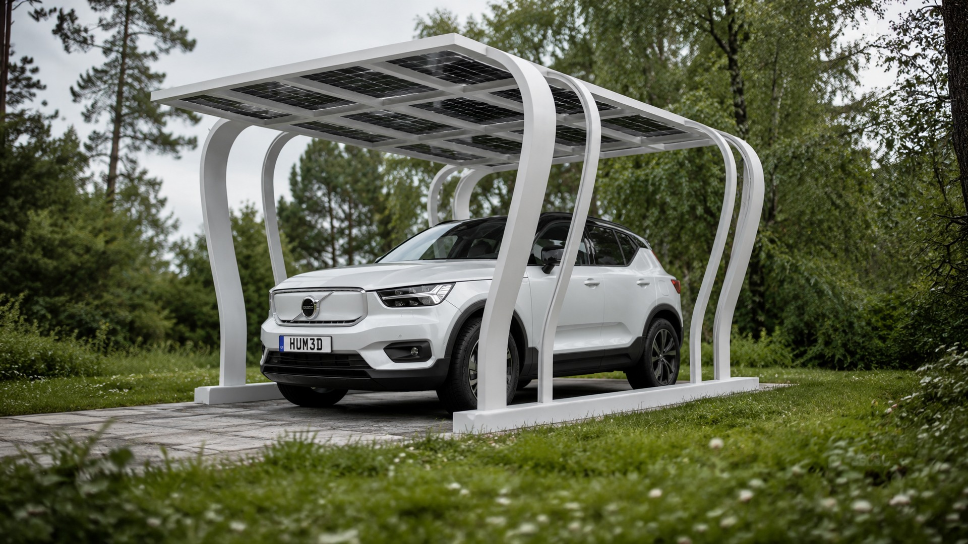 White Volvo XC40 parked under a solar-panel carport surrounded by forest